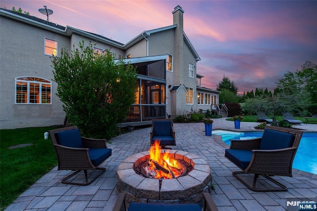 39 Crown View Ct, Sparta, NJ 07871 - patio terrace at dusk featuring an outdoor fire pit, a patio, and an outdoor pool