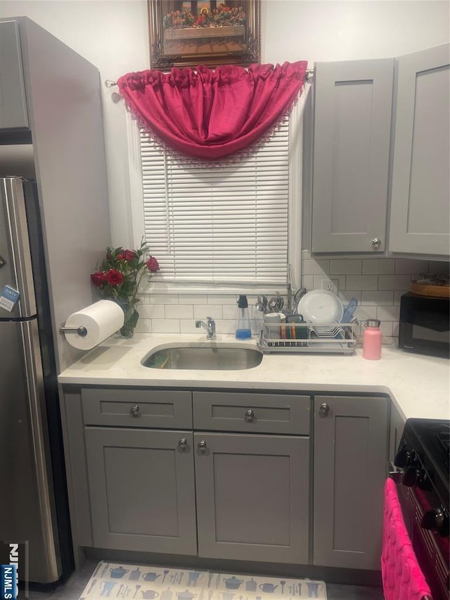 154 Butler St, Paterson, NJ 07524 - kitchen featuring black appliances, gray cabinetry, a sink, and light countertops