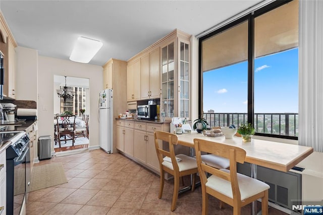 300 Winston Dr Unit 1817, Cliffside Park, NJ 07010 - kitchen featuring freestanding refrigerator, stainless steel microwave, black / electric stove, light tile patterned floors, and glass insert cabinets