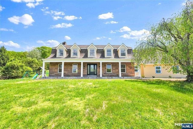11 Deer Meadow Rd, Warwick, NY 10990 - new england style home featuring a chimney, a front yard, a playground, stone siding, and covered porch