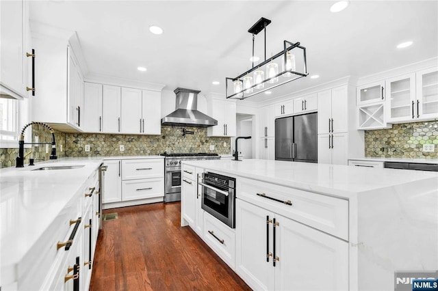 11 Deer Meadow Rd, Warwick, NY 10990 - kitchen featuring premium appliances, wall chimney range hood, a sink, tasteful backsplash, and white cabinets