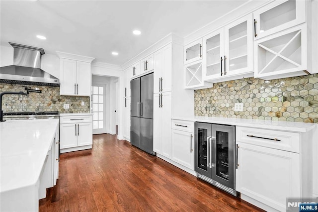 11 Deer Meadow Rd, Warwick, NY 10990 - kitchen with wall chimney range hood, beverage cooler, high quality fridge, light countertops, and dark wood-style floors