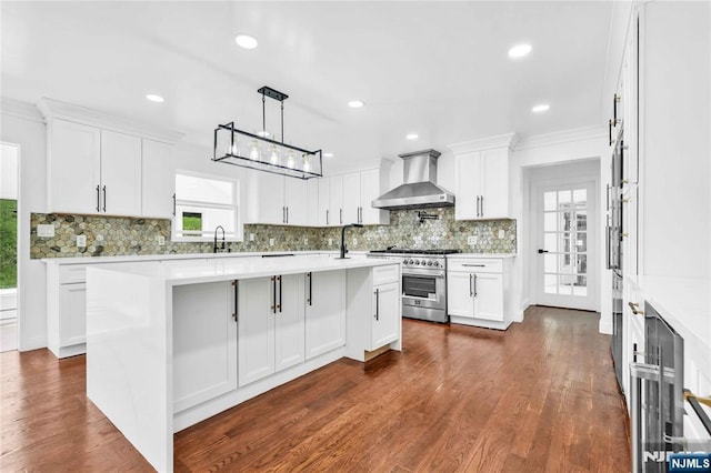 11 Deer Meadow Rd, Warwick, NY 10990 - kitchen with wall chimney exhaust hood, high end stove, decorative backsplash, an island with sink, and ornamental molding