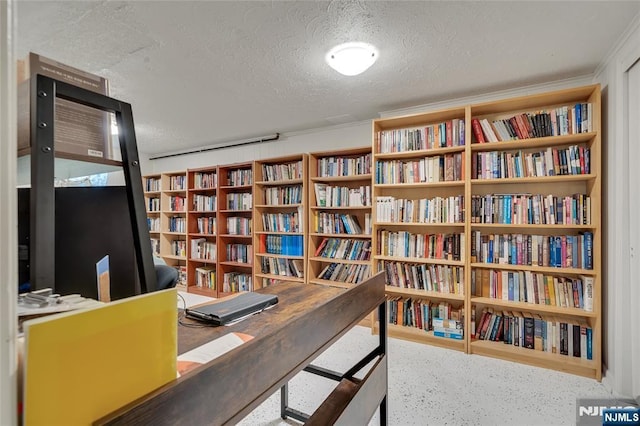 474 Laurel Brook Dr, Brick, NJ 08724 - living area featuring a textured ceiling, bookshelves, and speckled floor