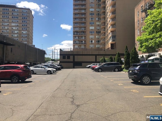 view of apartment building / complex featuring uncovered parking