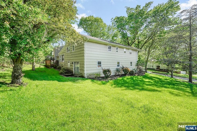 view of side of property with a lawn