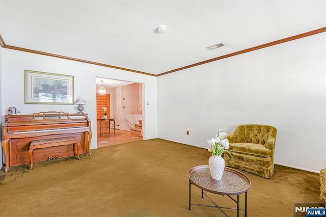 sitting room featuring stairway, ornamental molding, carpet flooring, and a chandelier