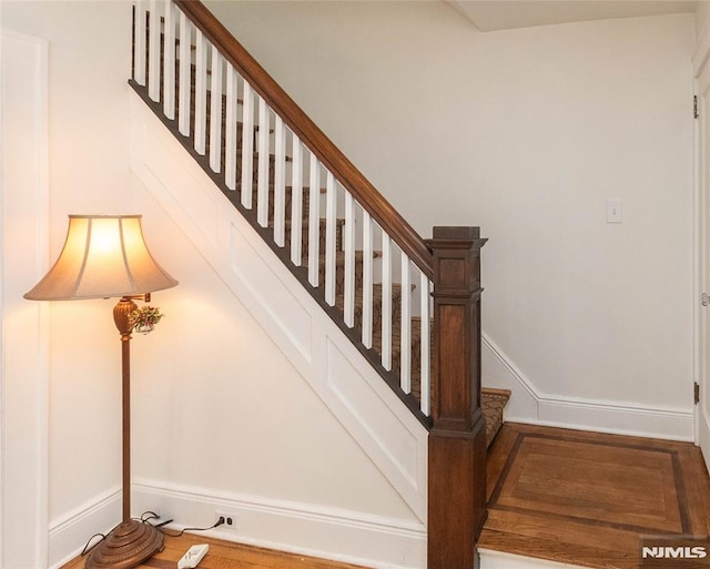 staircase featuring baseboards