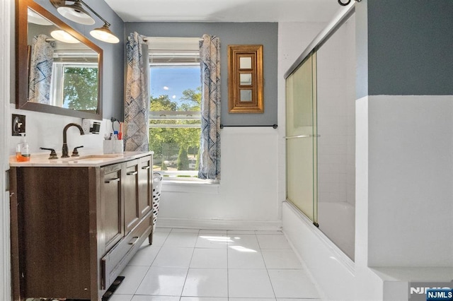 218 Waldo Pl, Englewood, NJ 07631 - full bath with tile patterned flooring, vanity, shower / bath combination with glass door, and baseboards
