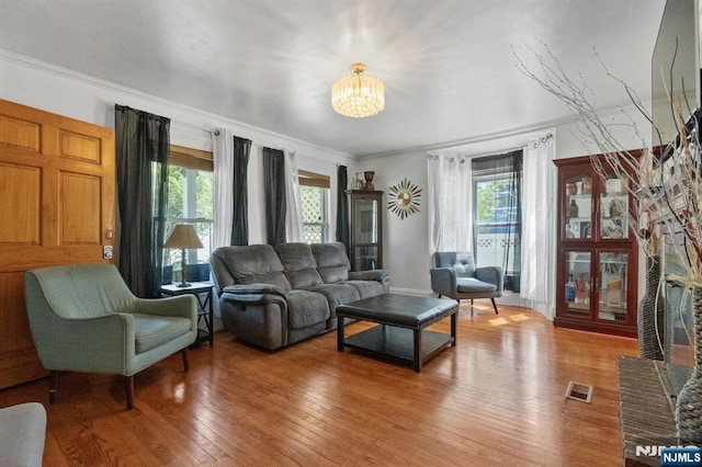 218 Waldo Pl, Englewood, NJ 07631 - living room featuring a chandelier, plenty of natural light, light wood-type flooring, and ornamental molding