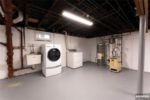 155 Liberty Rd, Teaneck, NJ 07666 - unfinished below grade area with water heater, separate washer and dryer, and a sink