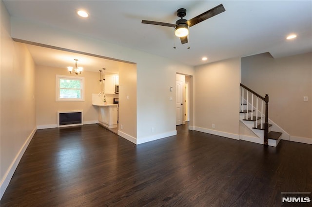 155 Liberty Rd, Teaneck, NJ 07666 - unfurnished living room with dark wood-type flooring, a chandelier, stairs, and recessed lighting
