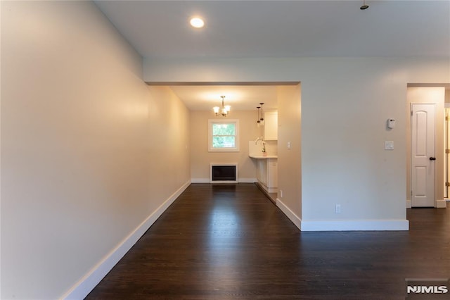 155 Liberty Rd, Teaneck, NJ 07666 - hallway featuring dark wood-style floors, baseboards, and a chandelier