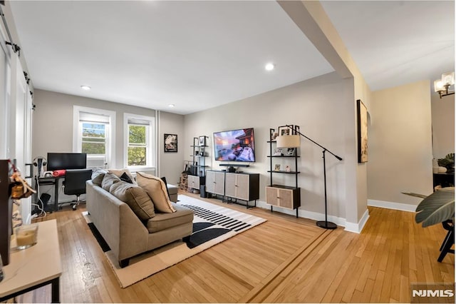 living room featuring light wood-type flooring, a desk, baseboards, a chandelier, and recessed lighting