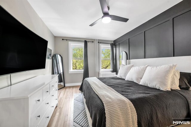bedroom featuring light wood-type flooring, ceiling fan, and baseboards