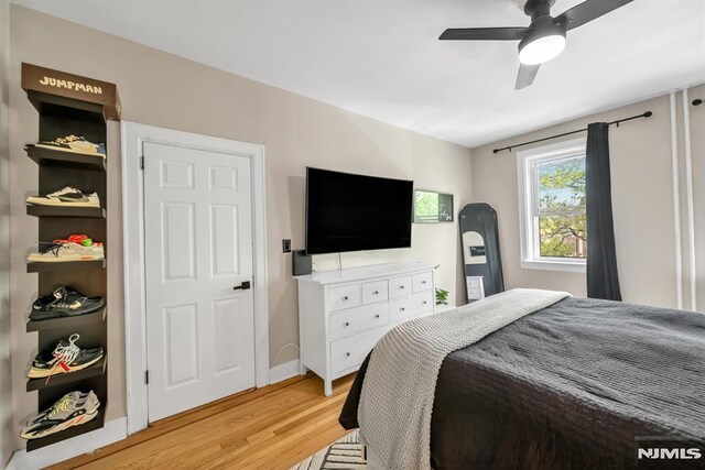 bedroom featuring light wood-type flooring and ceiling fan