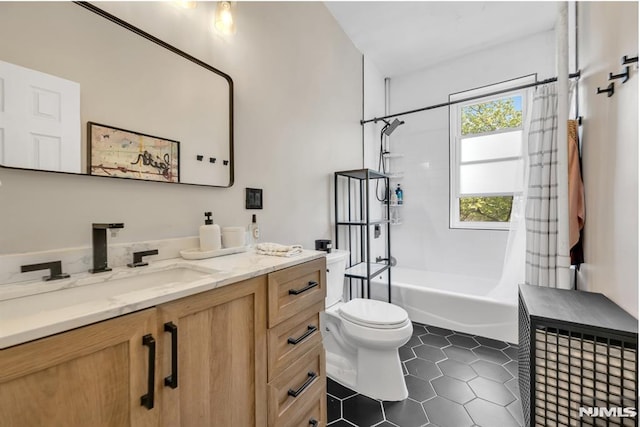 full bath featuring shower / bath combo with shower curtain, vanity, toilet, and tile patterned floors