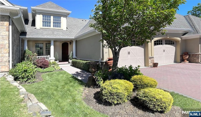 75 Windsor Ln, Ramsey, NJ 07446 - view of front facade with stucco siding, covered porch, and a garage