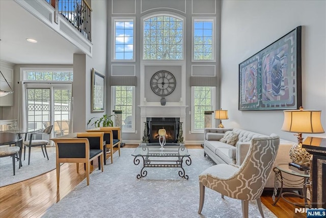75 Windsor Ln, Ramsey, NJ 07446 - living room with wood finished floors, a towering ceiling, and a glass covered fireplace