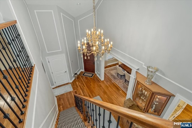 75 Windsor Ln, Ramsey, NJ 07446 - entryway with wood finished floors, a chandelier, baseboards, and stairs