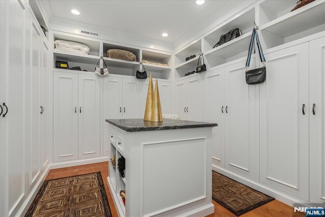 75 Windsor Ln, Ramsey, NJ 07446 - mudroom with wood finished floors, recessed lighting, crown molding, and a decorative wall