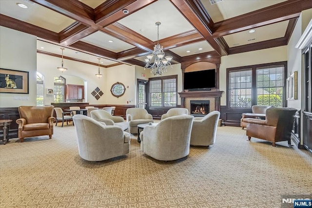 75 Windsor Ln, Ramsey, NJ 07446 - living room featuring coffered ceiling, beam ceiling, a glass covered fireplace, plenty of natural light, and a chandelier