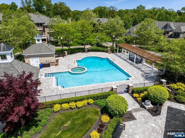 75 Windsor Ln, Ramsey, NJ 07446 - view of swimming pool featuring fence, a patio area, a pool with connected hot tub, and view of scattered trees