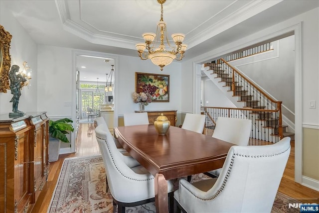 75 Windsor Ln, Ramsey, NJ 07446 - dining space featuring a chandelier, wood finished floors, stairway, crown molding, and a raised ceiling