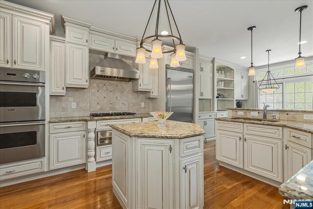 75 Windsor Ln, Ramsey, NJ 07446 - kitchen with stainless steel appliances, a sink, dark wood-style floors, tasteful backsplash, and exhaust hood
