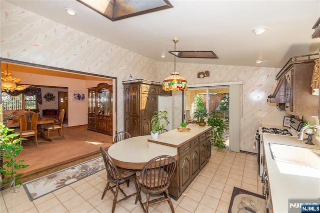 dining area with wallpapered walls, light tile patterned floors, a skylight, and recessed lighting