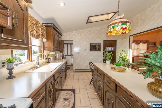 kitchen featuring wallpapered walls, light countertops, a baseboard radiator, a sink, and light tile patterned flooring