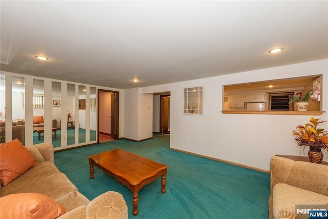 carpeted living area with recessed lighting and baseboards