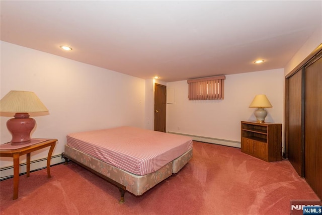 bedroom featuring a baseboard heating unit, carpet flooring, recessed lighting, and a closet