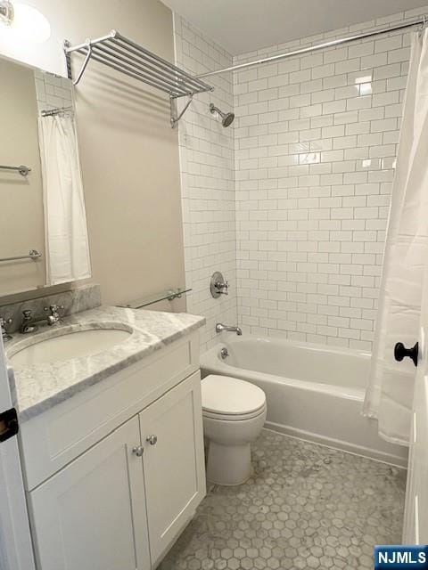 bathroom featuring shower / bath combination with curtain, vanity, and toilet