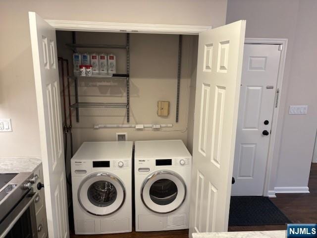laundry room featuring washing machine and dryer and dark wood-style floors