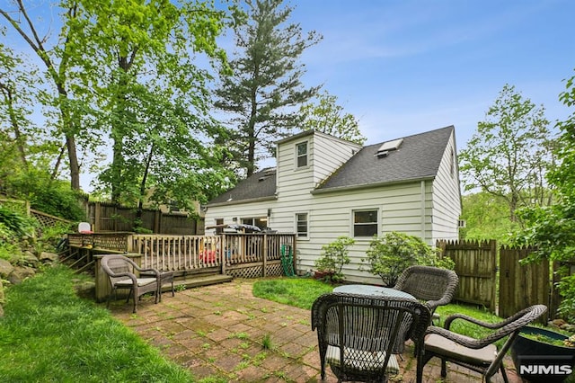 11 Beech Ct, Ringwood, NJ 07456 - back of house with a fenced backyard, roof with shingles, a deck, and a patio area