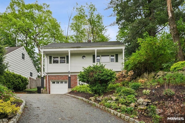 11 Beech Ct, Ringwood, NJ 07456 - view of front of property featuring driveway, brick siding, an attached garage, and a chimney