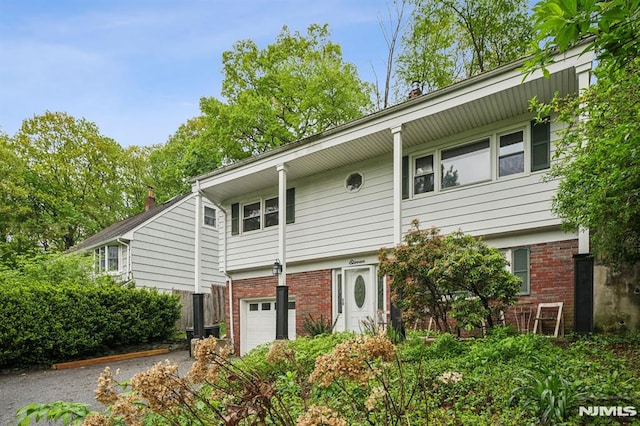 11 Beech Ct, Ringwood, NJ 07456 - view of front of property featuring brick siding, driveway, and a garage