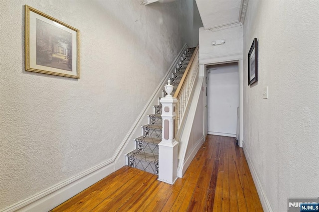 136 Shippen St, Weehawken, NJ 07086 - staircase with hardwood / wood-style flooring, a textured wall, and baseboards