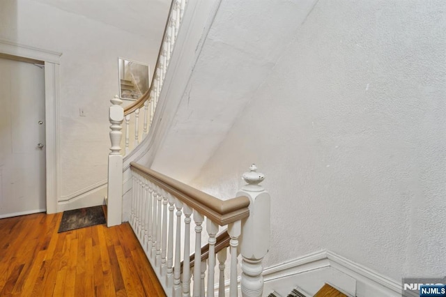136 Shippen St, Weehawken, NJ 07086 - stairway featuring wood finished floors and baseboards