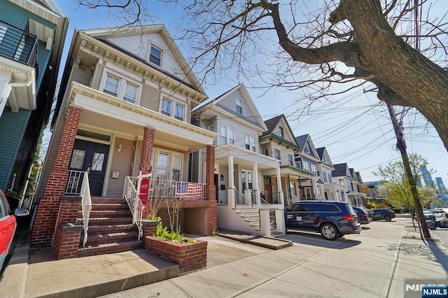 136 Shippen St, Weehawken, NJ 07086 - view of front of home with a porch, a residential view, and brick siding