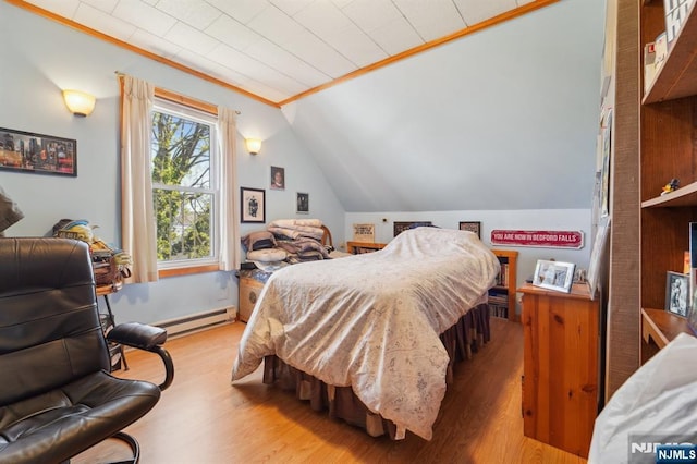 136 Shippen St, Weehawken, NJ 07086 - bedroom featuring a baseboard heating unit, wood finished floors, and vaulted ceiling