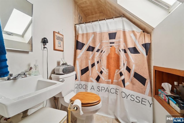 136 Shippen St, Weehawken, NJ 07086 - bathroom view of a skylight, toilet, a sink, and a shower with curtain