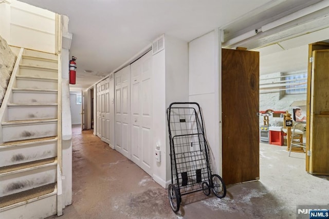 136 Shippen St, Weehawken, NJ 07086 - hall with unfinished concrete floors and stairs