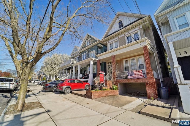 136 Shippen St, Weehawken, NJ 07086 - view of front of house featuring brick siding and a porch