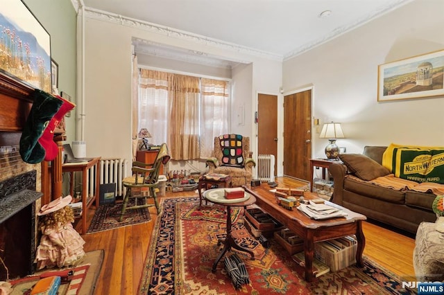 136 Shippen St, Weehawken, NJ 07086 - living room featuring radiator heating unit, crown molding, and wood finished floors