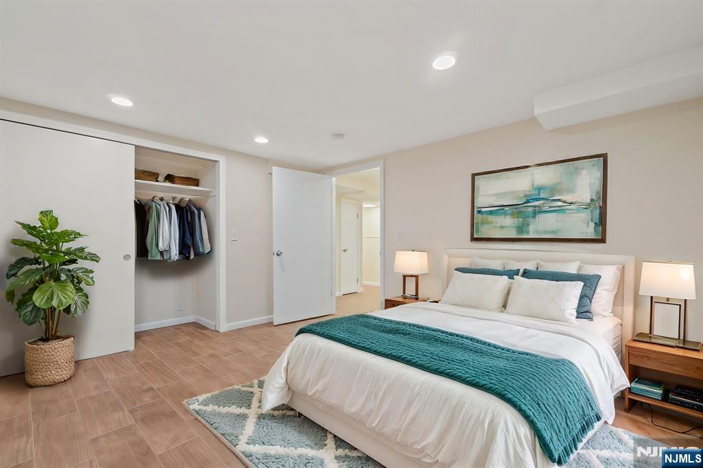 bedroom with light wood-style flooring, recessed lighting, a closet, and baseboards