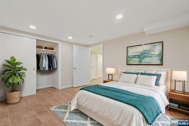bedroom with light wood-style flooring, recessed lighting, a closet, and baseboards