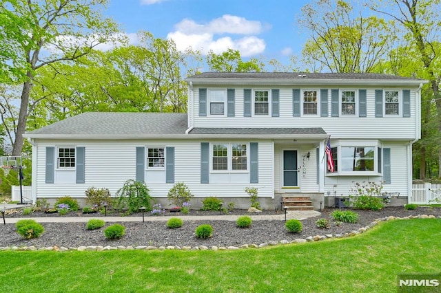 colonial-style house featuring entry steps