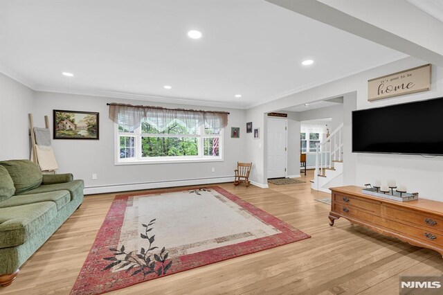 living area with a baseboard heating unit, wood finished floors, ornamental molding, stairs, and recessed lighting